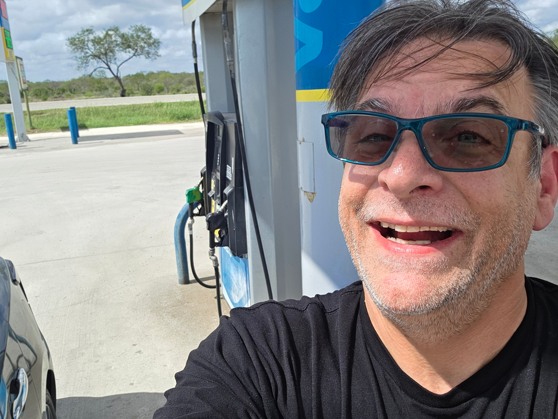 Eric Benson, the field agent, taking a selfie at a gas station pump